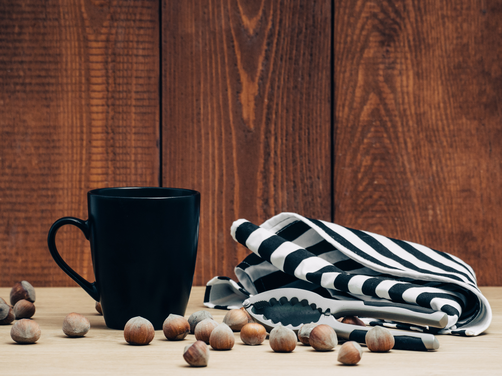 Black Ceramic Mug Surrounded by Chestnuts